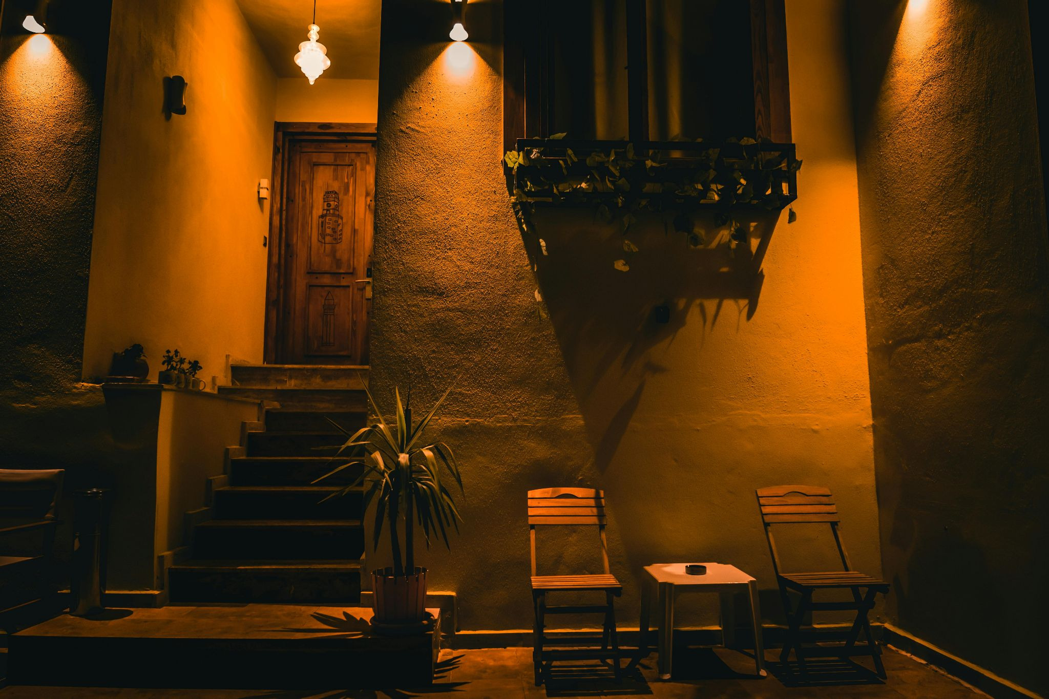 Warmly lit patio with potted plant and furniture