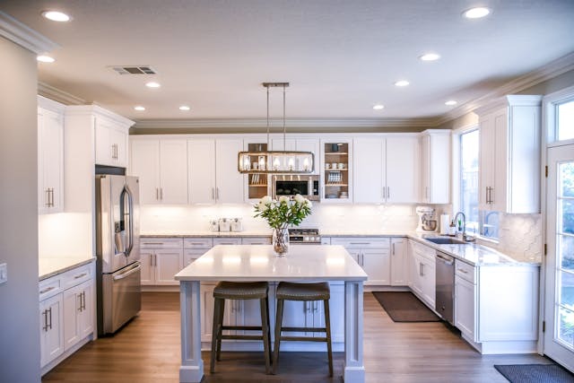 Large open kitchen with white cabinets and an island in the center